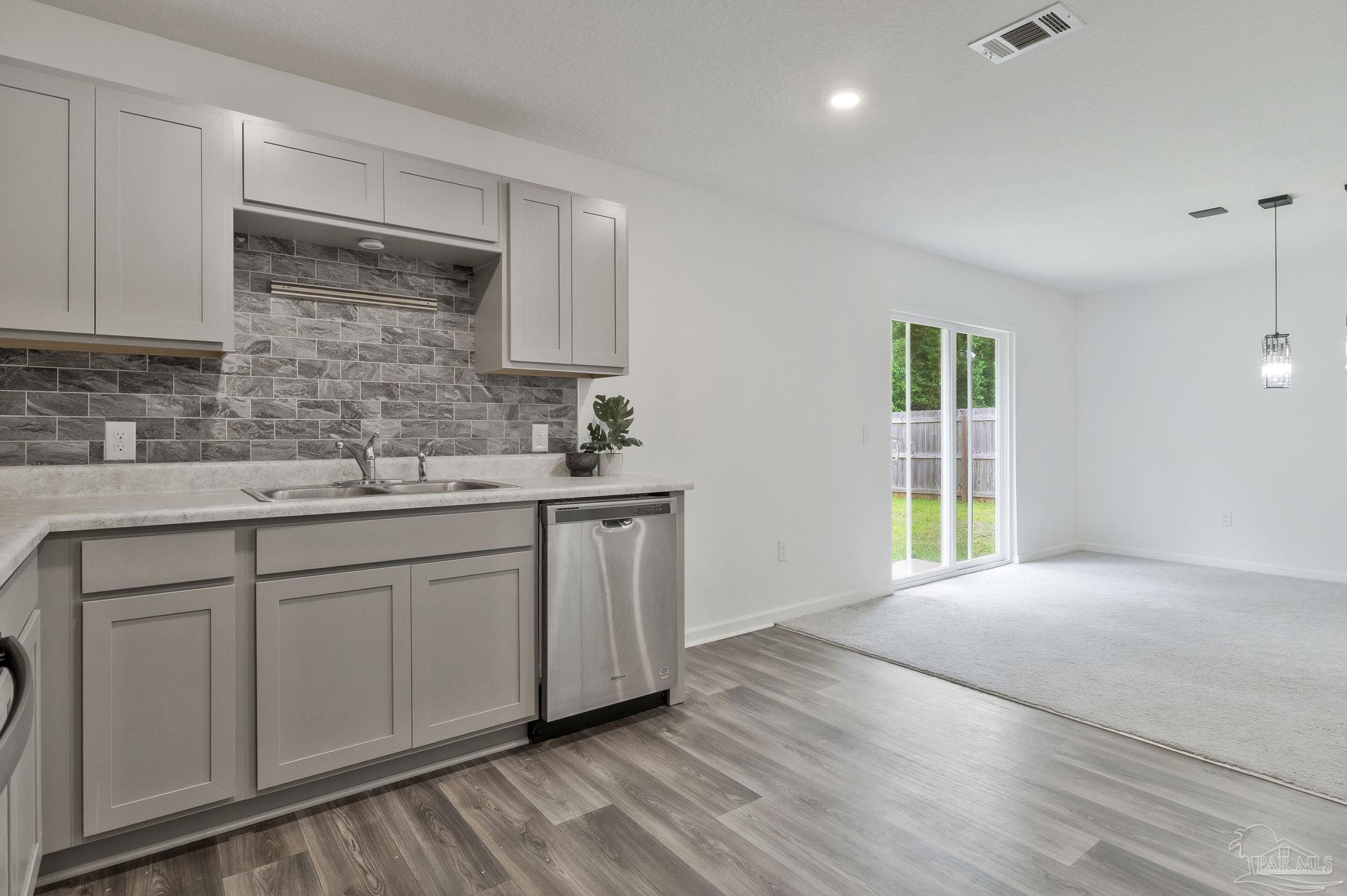 1625 Addies Way Pensacola, FL 32534 - Photo 22 of 50 a kitchen with a sink and cabinets