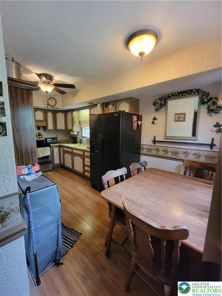 320 Hillside Street Forest City, PA 18421 - Photo 6 of 24 a living room with furniture a flat screen tv and kitchen view
