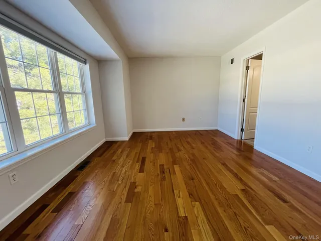 a bathroom with a toilet sink vanity and mirror