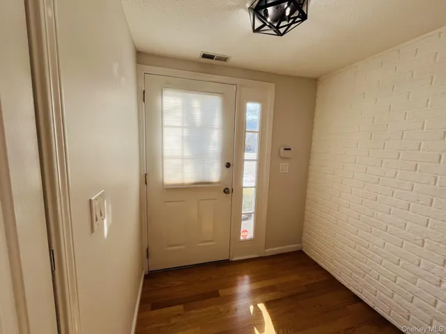 a view of an empty room and wooden floor