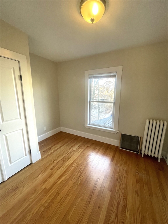 22 Mansfield Street, Unit 2 Boston, MA 02134 - Photo 13 of 18 a view of empty room with wooden floor and fan