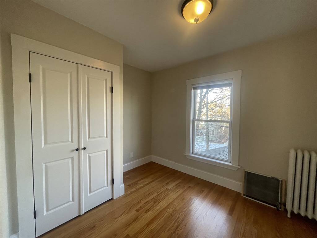 22 Mansfield Street, Unit 2 Boston, MA 02134 - Photo 18 of 18 an empty room with wooden floor and windows