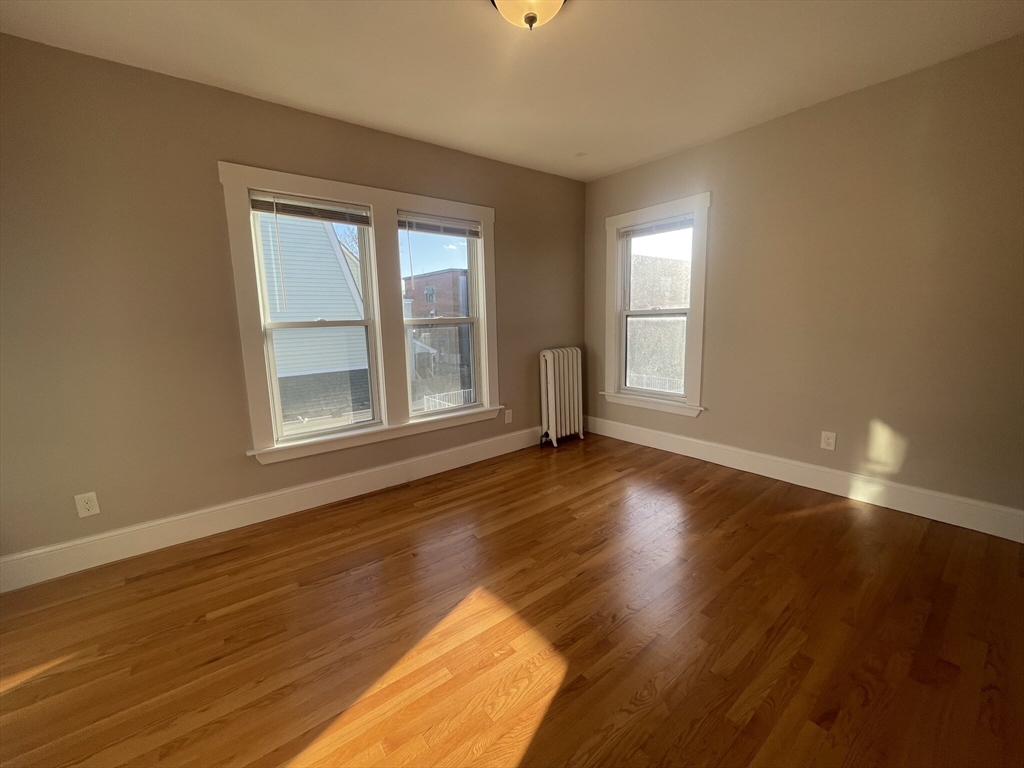 22 Mansfield Street, Unit 2 Boston, MA 02134 - Photo 4 of 18 a view of empty room with wooden floor and fan