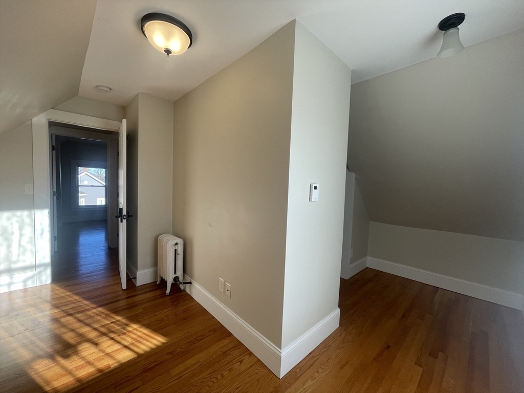 22 Mansfield Street, Unit 2 Boston, MA 02134 - Photo 6 of 18 an empty room with wooden floor and windows
