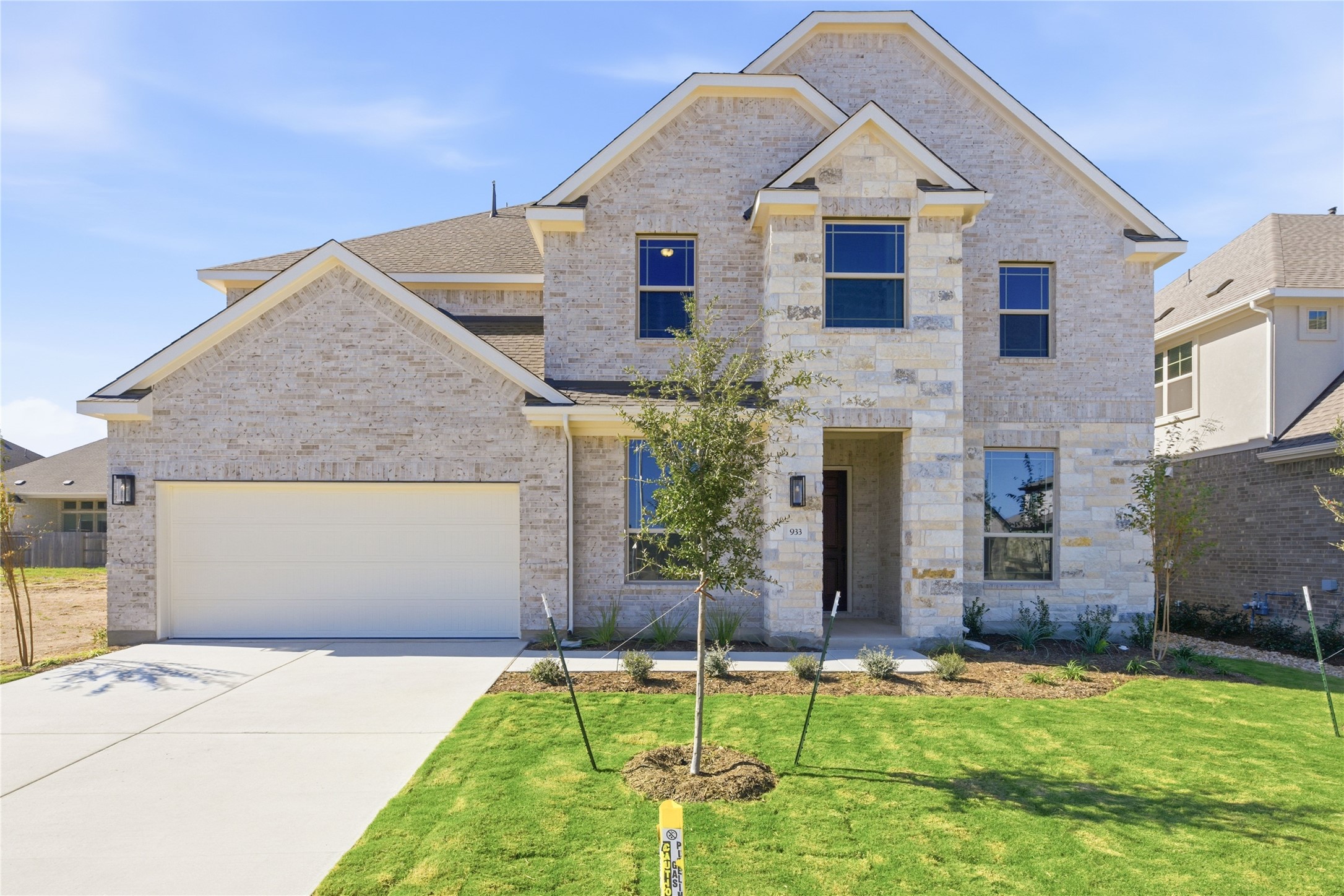 933 Sunny Ridge Drive Leander, TX 78641 - Photo 1 of 1 View of front of property with brick siding, concrete driveway, a front yard, an attached garage, and a shingled roof