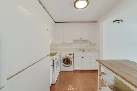 a utility room with sink dryer and washer
