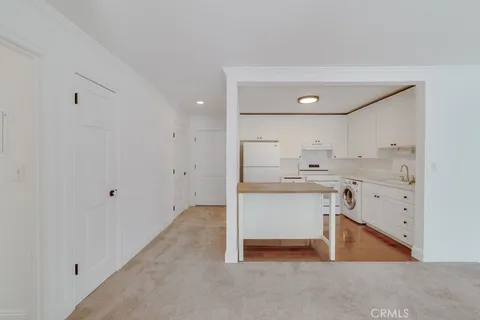 a room with a sink cabinets and a window
