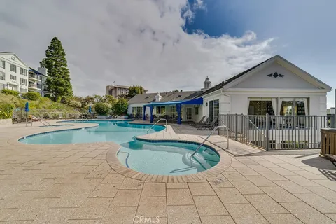 a view of a house with swimming pool and sitting area