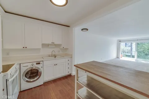 a utility room with sink dryer and washer