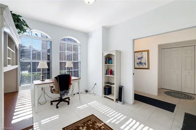 a view of a livingroom with workspace and a window