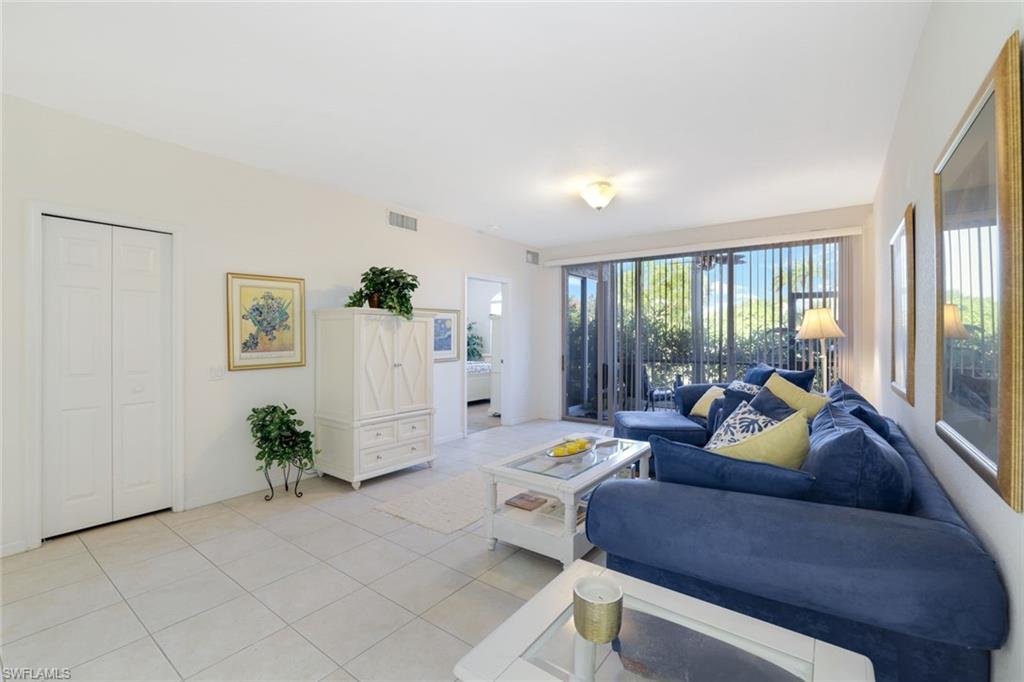 10049 Heather Lane, Unit 101 Naples, FL 34119 - Photo 3 of 25 a living room with furniture and a large window