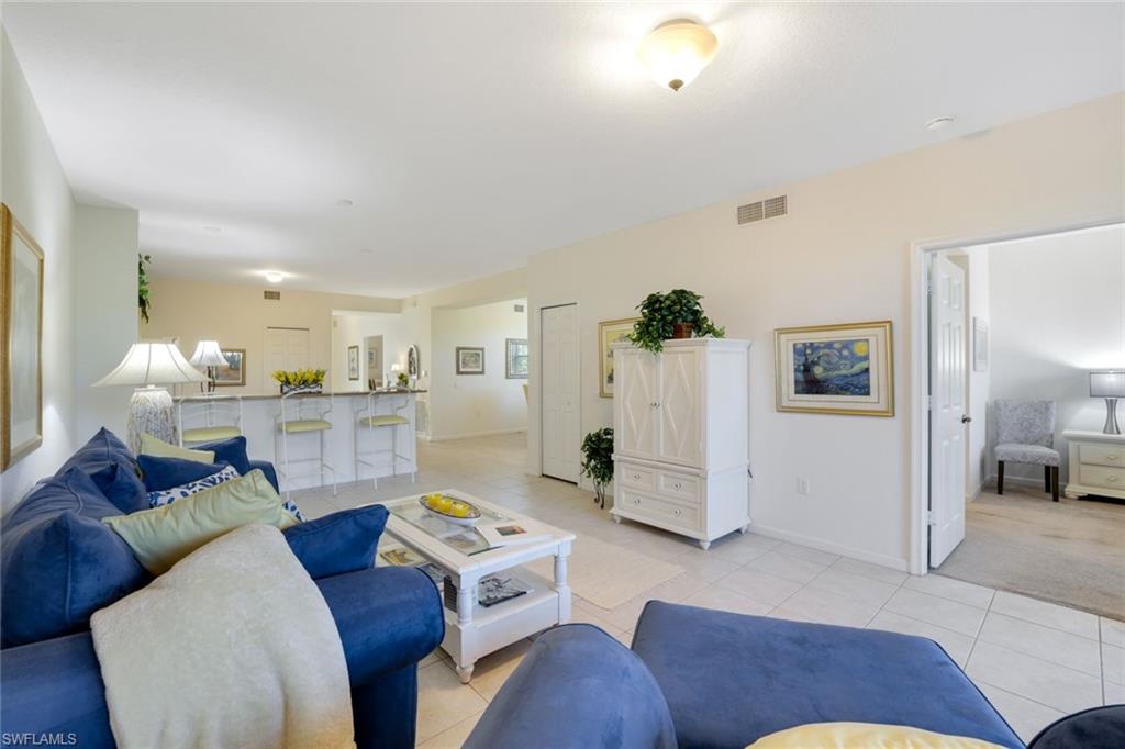 10049 Heather Lane, Unit 101 Naples, FL 34119 - Photo 6 of 25 a living room with furniture and wooden floor