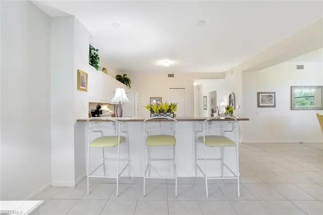 a dining room with furniture and a kitchen view