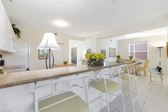 a kitchen with stainless steel appliances kitchen island granite countertop a sink and cabinets