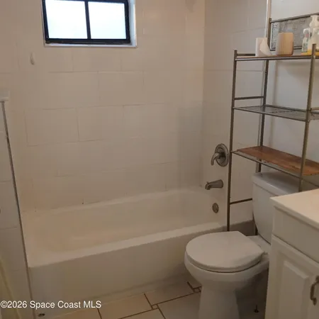 a bathroom with a sink a toilet and bathtub