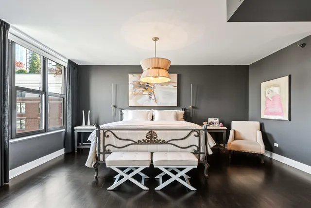 a bedroom with a bed and a chandelier