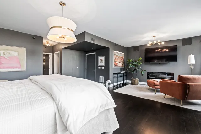 a bed room with a bed and a chandelier