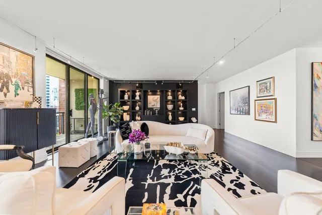 a very nice looking room with a large window and furniture