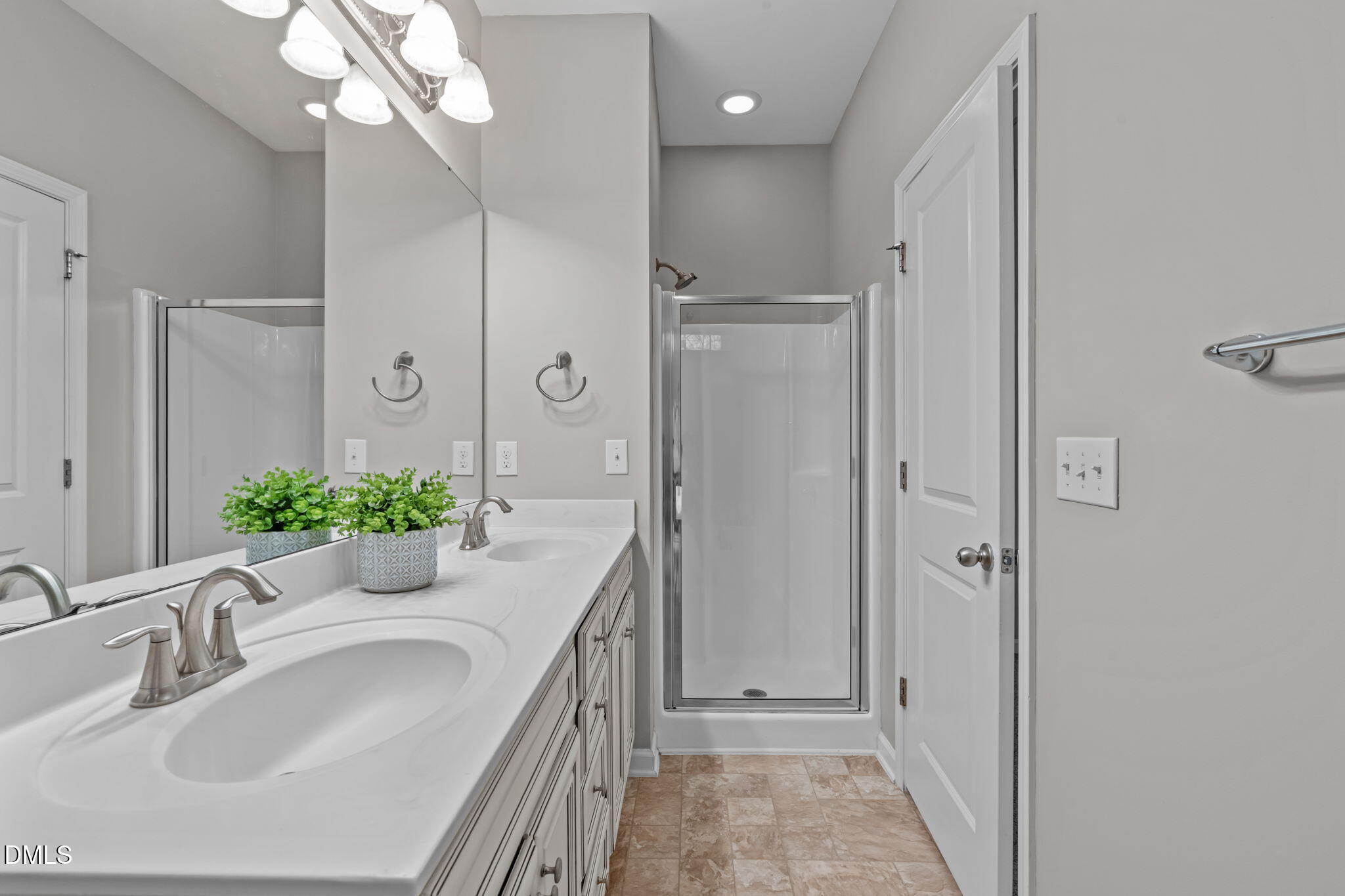 738 Wickham Ridge Road Apex, NC 27539 - Photo 13 of 27 a bathroom with a granite countertop sink a mirror and a shower