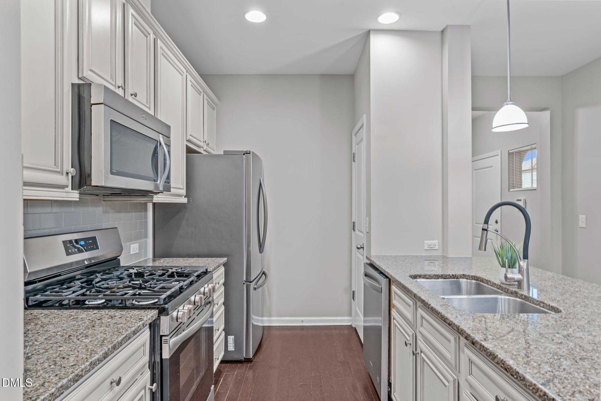 738 Wickham Ridge Road Apex, NC 27539 - Photo 3 of 27 a kitchen with stainless steel appliances granite countertop a sink stove and refrigerator