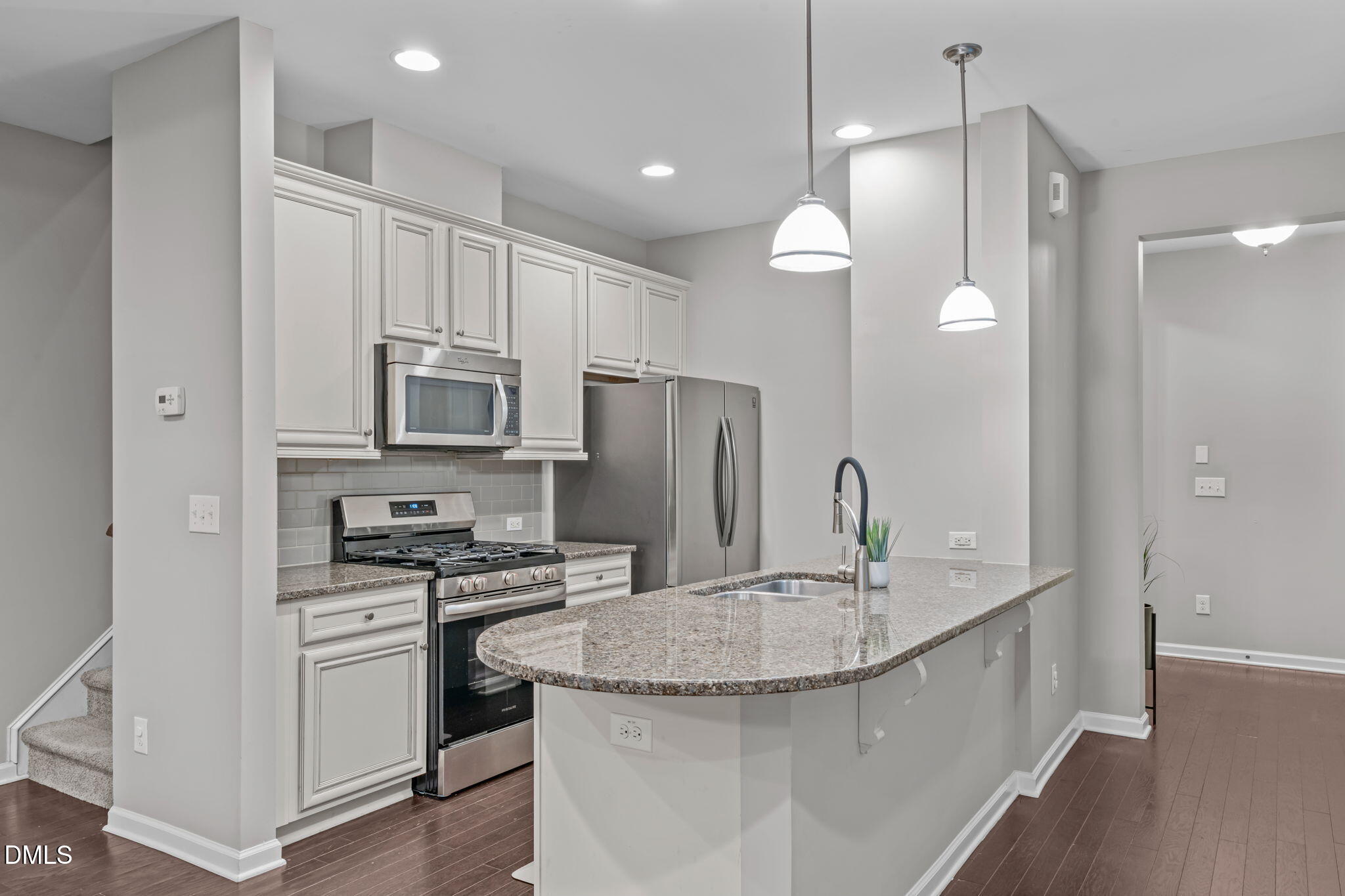 738 Wickham Ridge Road Apex, NC 27539 - Photo 3 of 27 a kitchen with stainless steel appliances granite countertop a sink stove and refrigerator