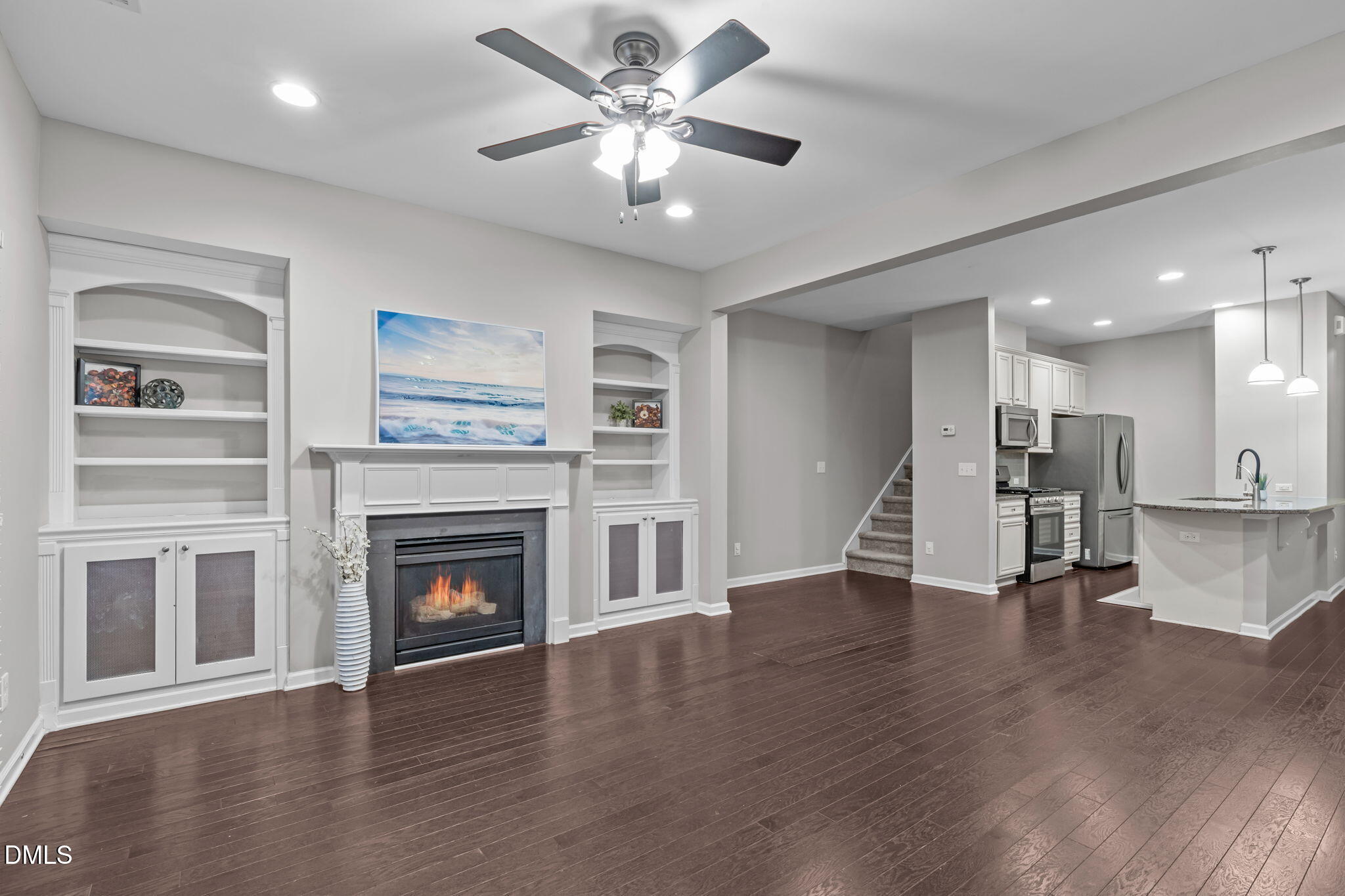 738 Wickham Ridge Road Apex, NC 27539 - Photo 5 of 27 a view of an empty room with wooden floor and a fireplace