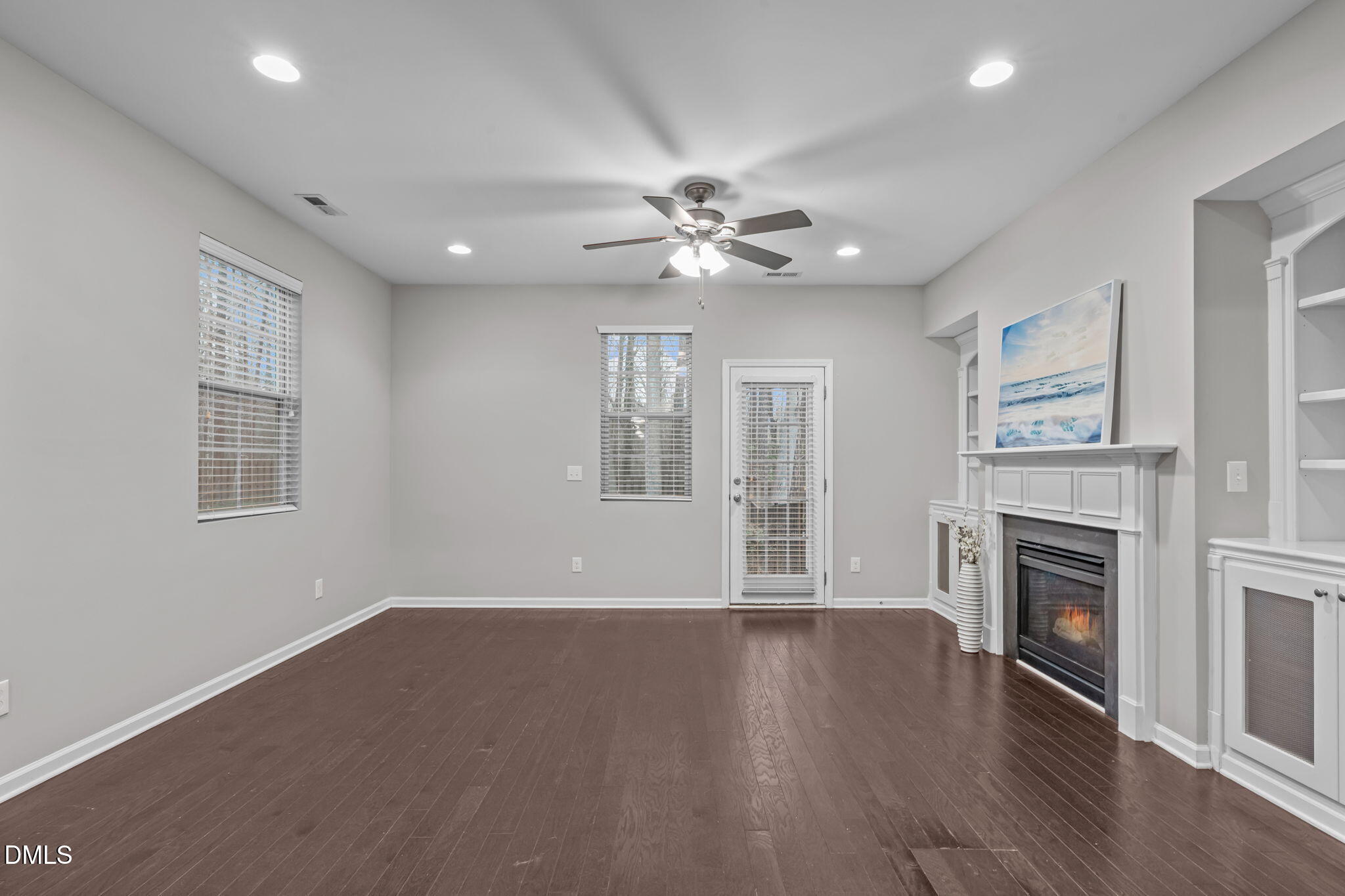 738 Wickham Ridge Road Apex, NC 27539 - Photo 6 of 27 a view of an empty room with a fireplace and a window