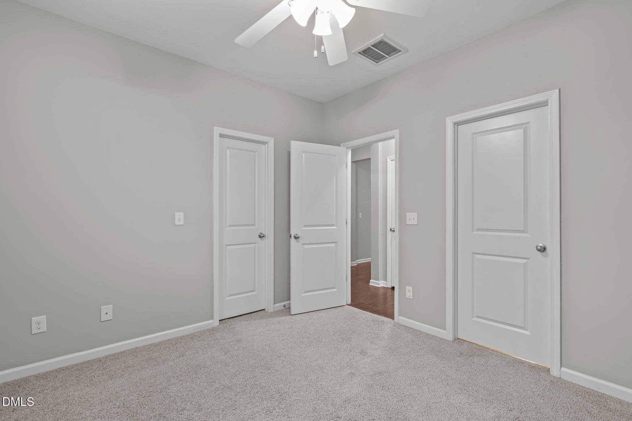 738 Wickham Ridge Road Apex, NC 27539 - Photo 7 of 27 an empty room with a chandelier fan and closet area