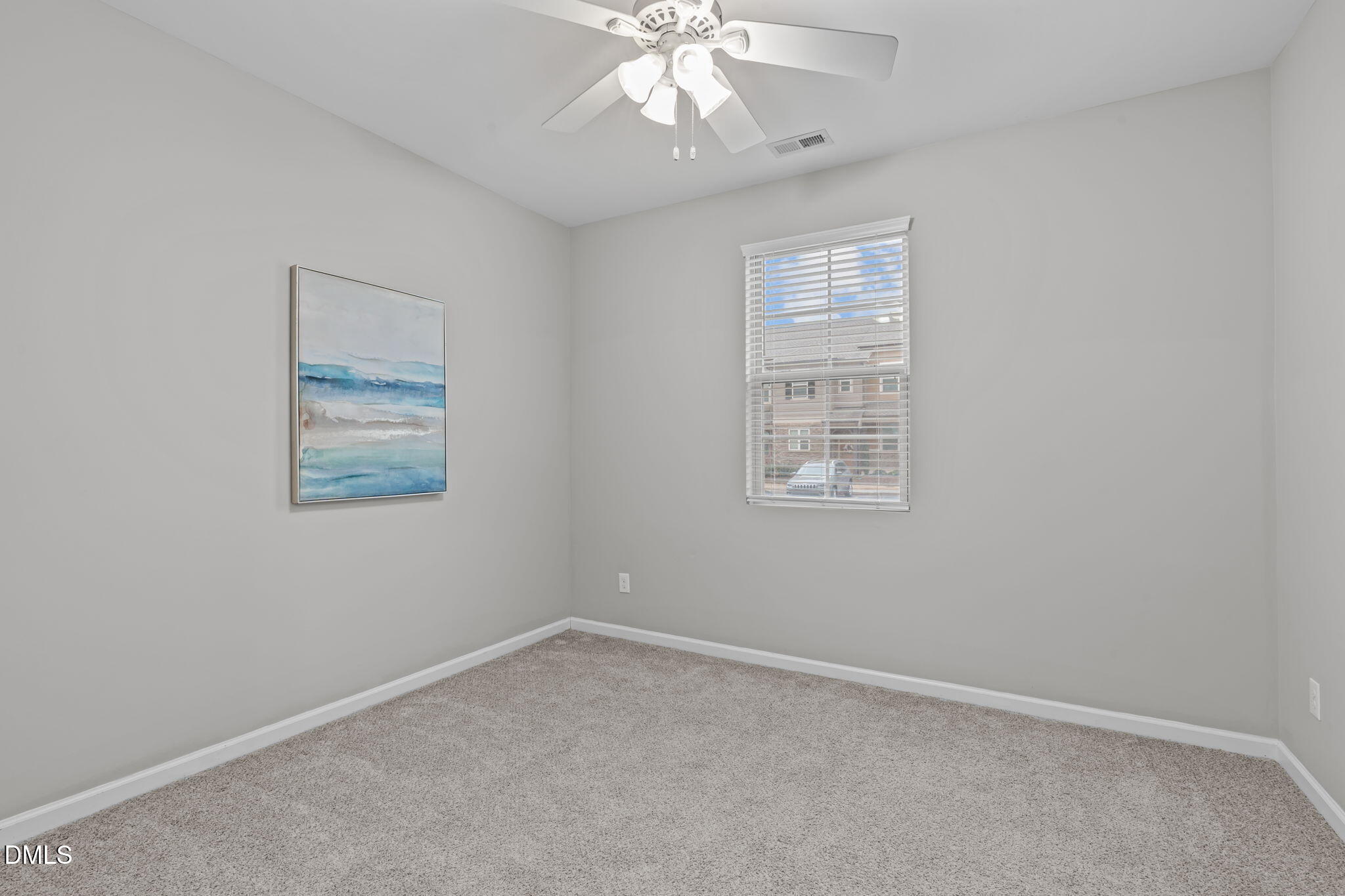 738 Wickham Ridge Road Apex, NC 27539 - Photo 8 of 27 an empty room with windows and fan