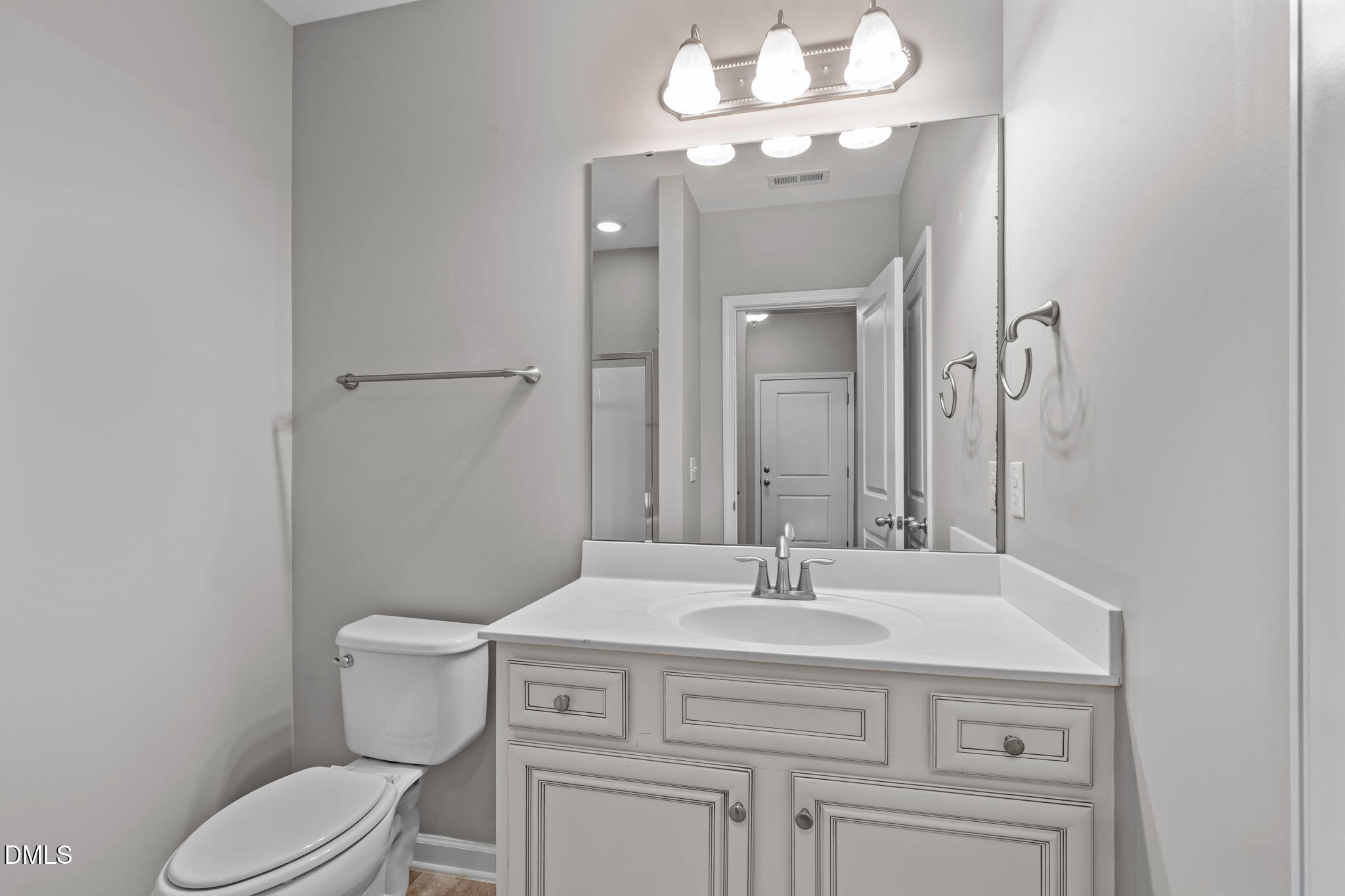 738 Wickham Ridge Road Apex, NC 27539 - Photo 9 of 27 a bathroom with a sink vanity mirror and toilet