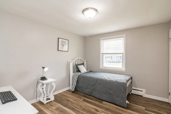 a bedroom with a bed and a window