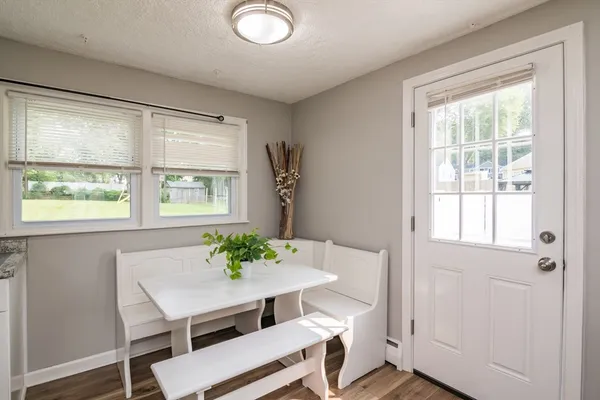 a view of a dining room with furniture window and wooden floor