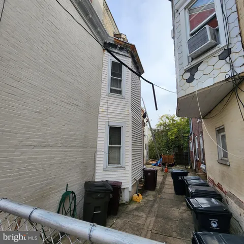a view of a patio with couches table and chairs with potted plants