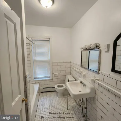 a room with furniture a flat screen tv and a window