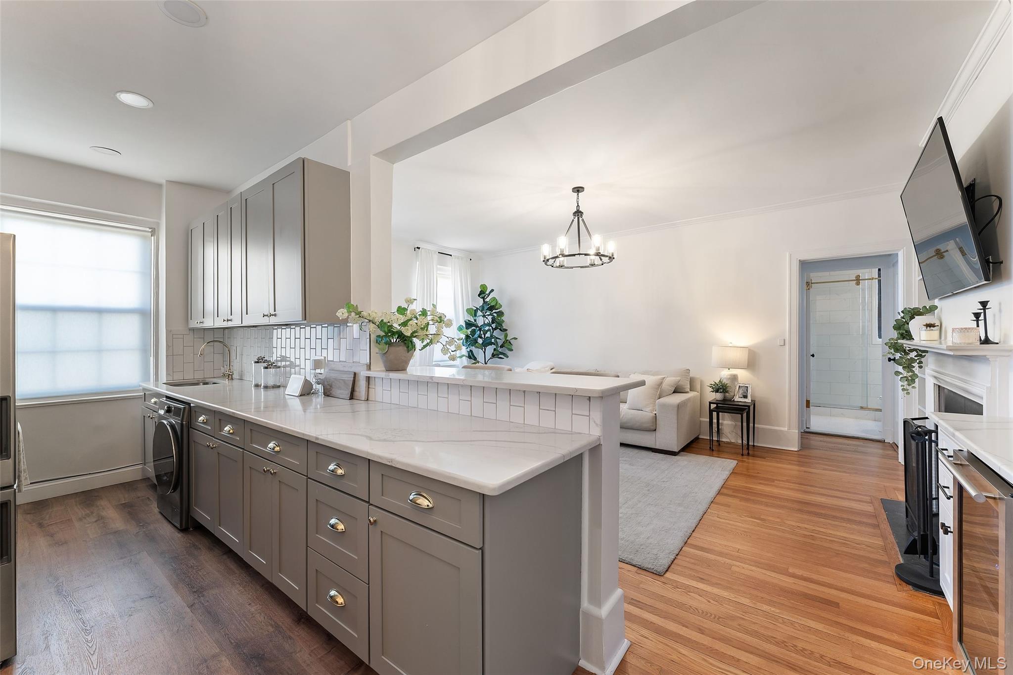 840 Bronx River Road, Unit 5B Bronxville, NY 10708 - Photo 2 of 11 Fully updated Kitchen featuring hardwood floors, quartz countertop, ample cabinetry and opens into Living Room.