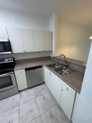 a kitchen with a sink and cabinets