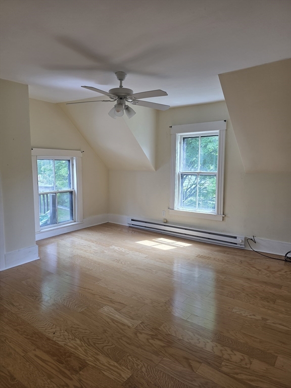 48 Maple Street, Unit 2 Holden, MA 01520 - Photo 9 of 11 a view of an empty room with a window and wooden floor