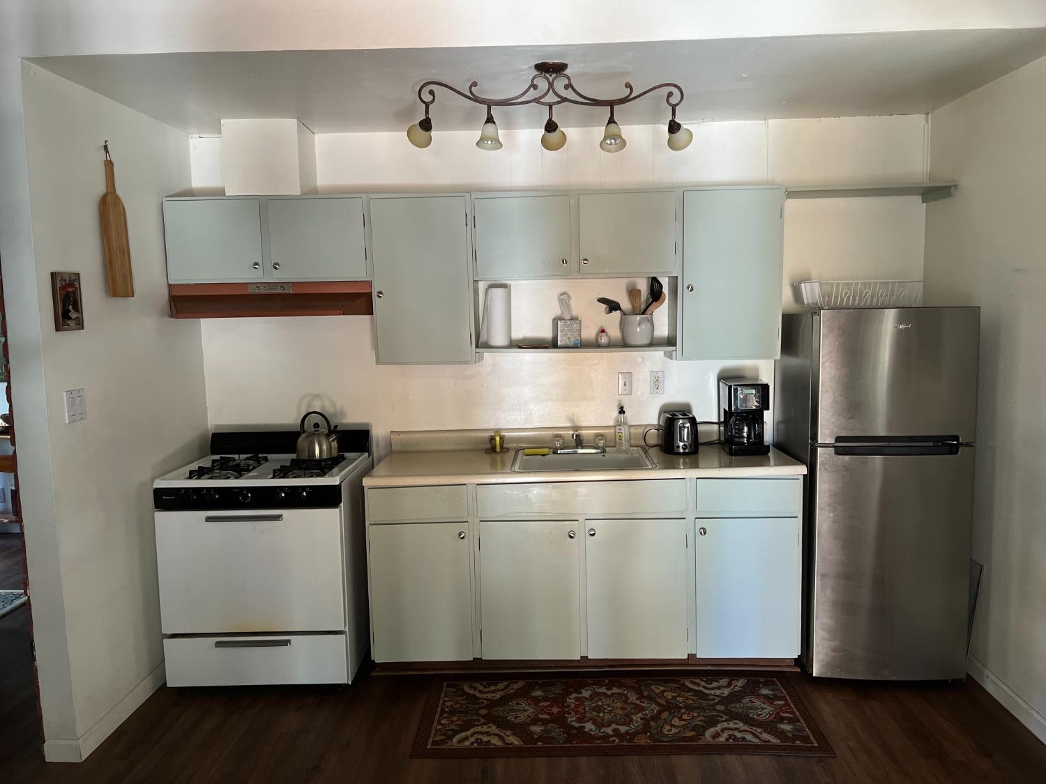 26445 Crystal Road Long Barn, CA 95335 - Photo 20 of 22 a kitchen with stainless steel appliances a sink and cabinets