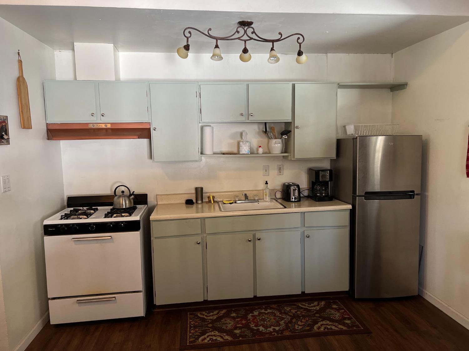 26445 Crystal Road Long Barn, CA 95335 - Photo 2 of 22 a kitchen with stainless steel appliances a sink a stove and refrigerator