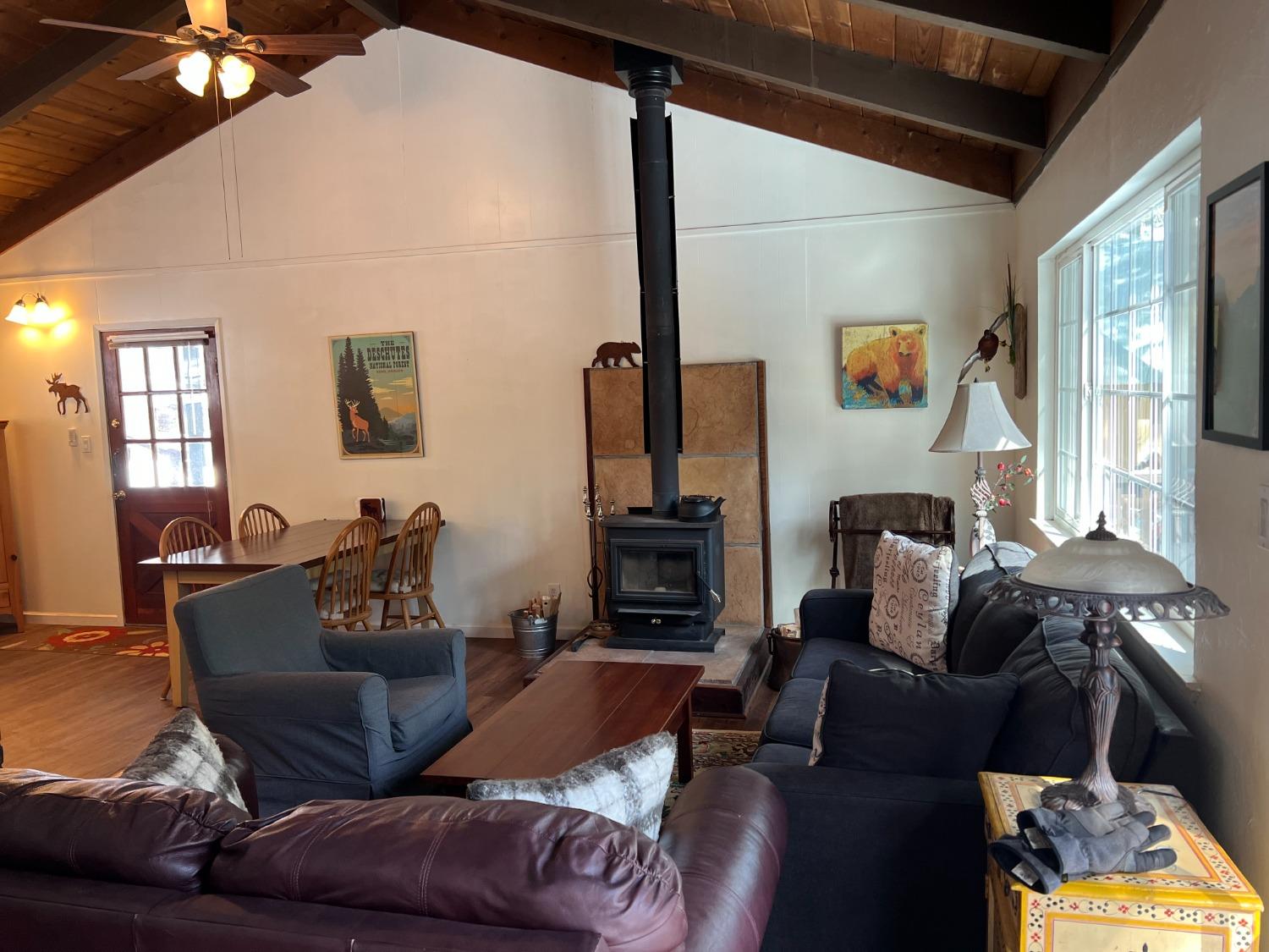 26445 Crystal Road Long Barn, CA 95335 - Photo 10 of 22 a living room with furniture a flat screen tv and a fireplace