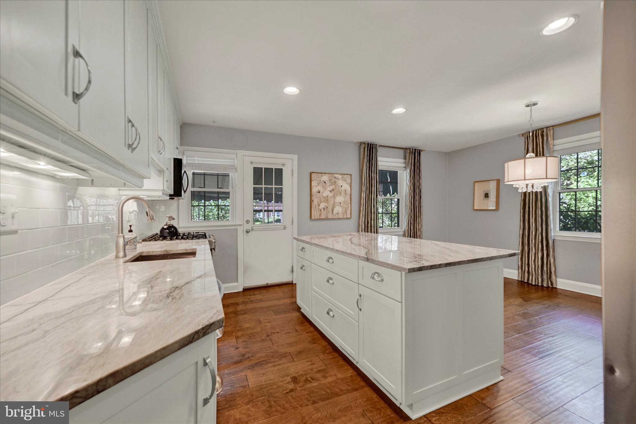 7220 Lanark Road Baltimore, MD 21212 - Photo 12 of 28 a large kitchen with stainless steel appliances granite countertop a lot of counter space and wooden floor
