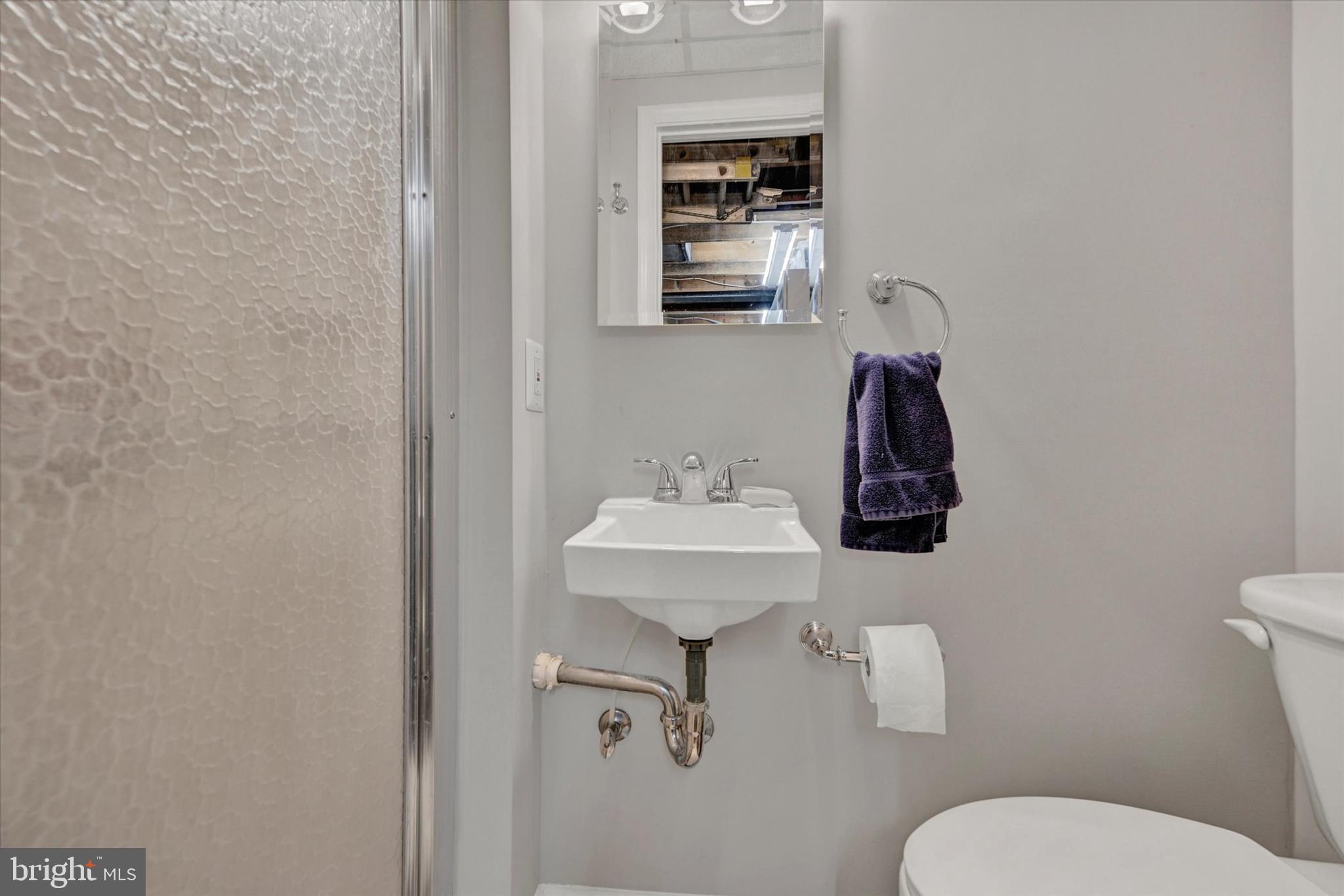 7220 Lanark Road Baltimore, MD 21212 - Photo 22 of 28 a bathroom with a toilet sink and mirror