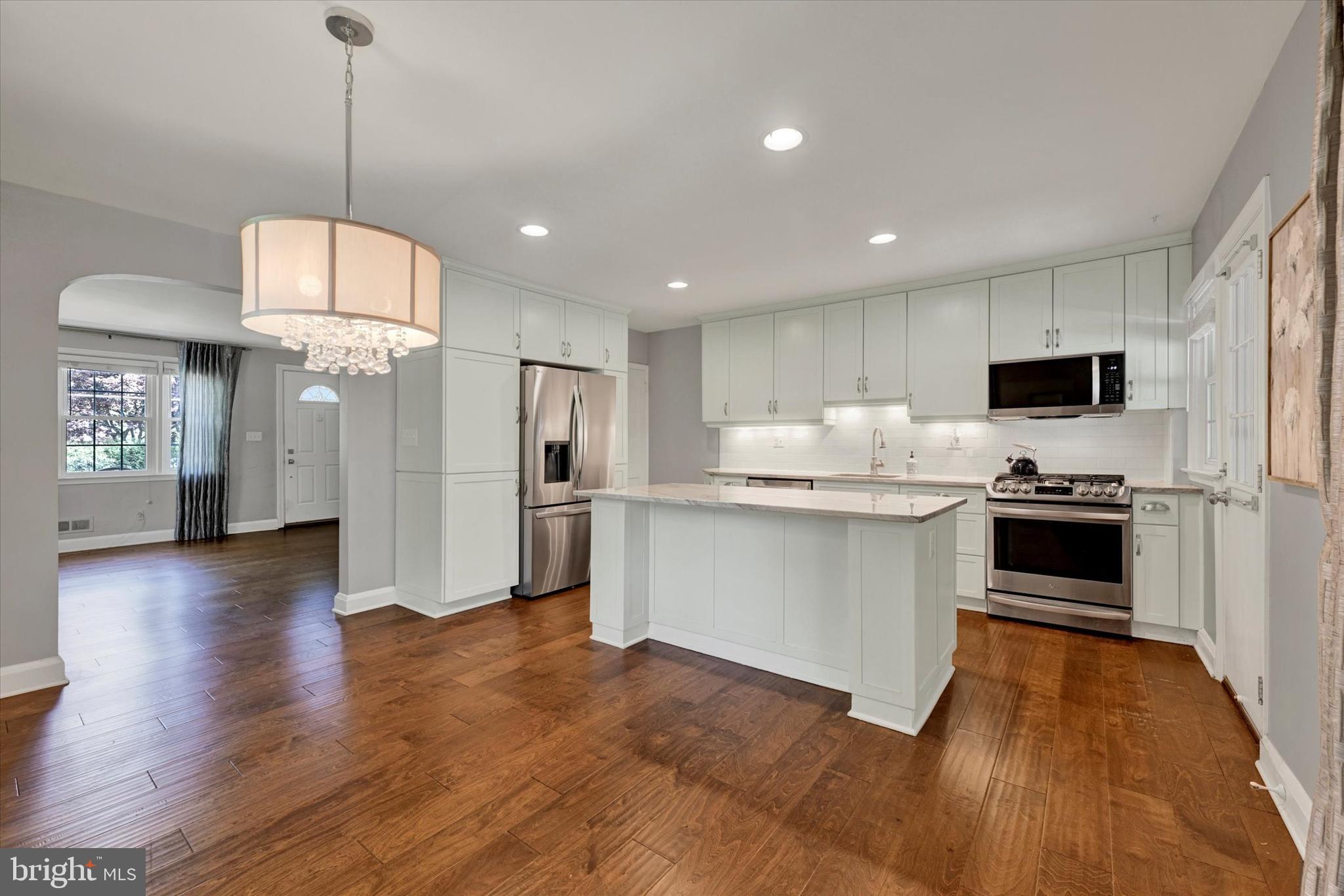 7220 Lanark Road Baltimore, MD 21212 - Photo 7 of 28 a kitchen with white cabinets and stainless steel appliances