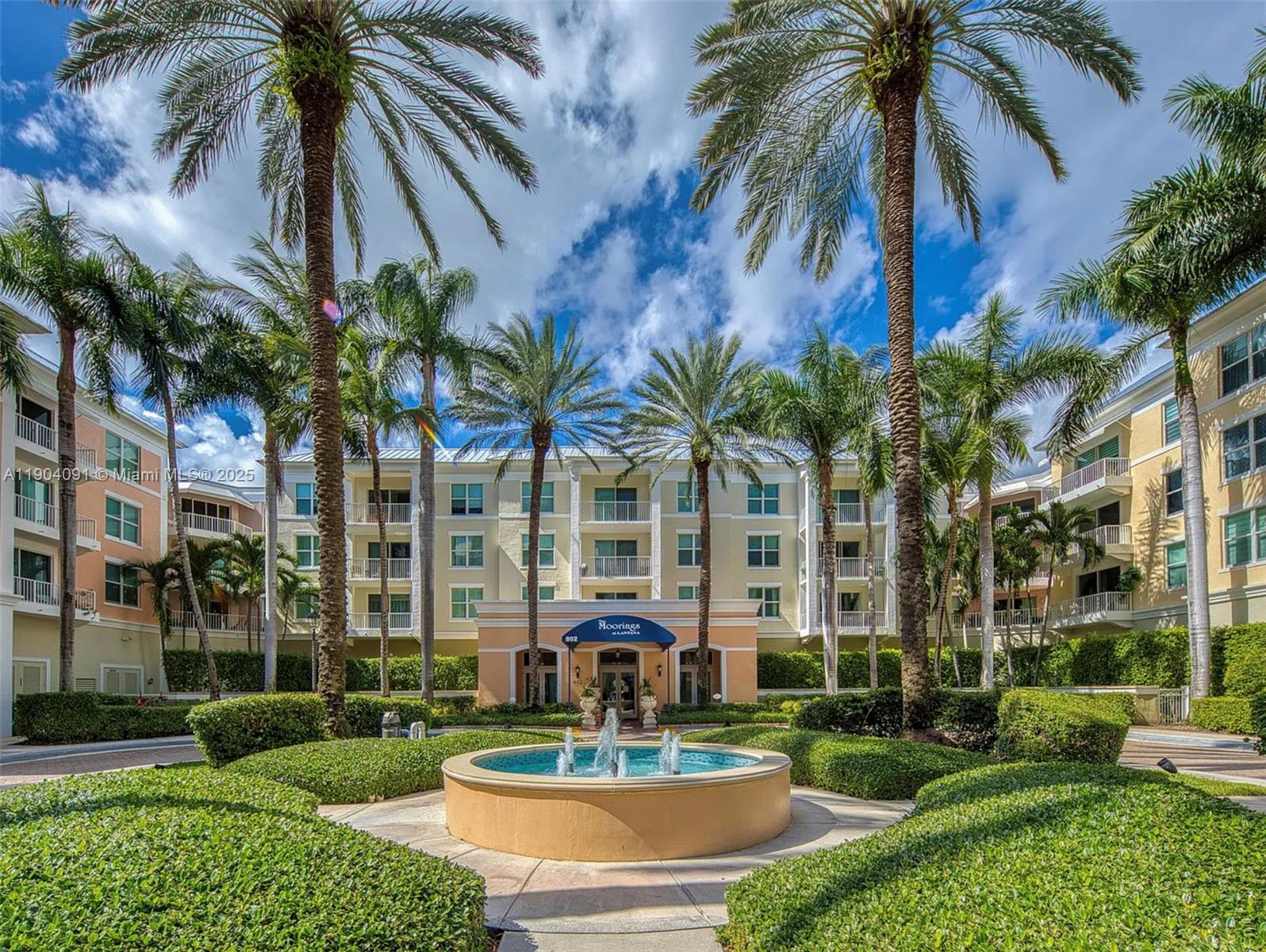 802 West Windward Way, Unit 411 Lantana, FL 33462 - Photo 1 of 42 a front view of multi story residential apartment building with yard and green space