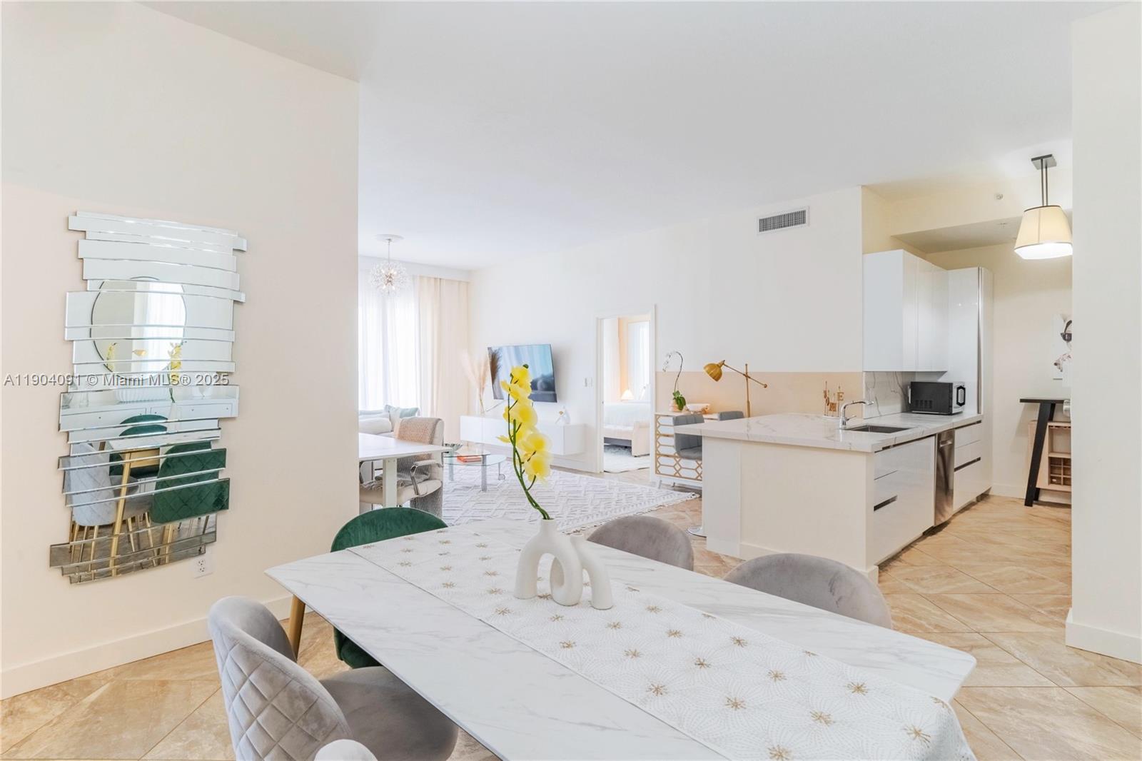 802 West Windward Way, Unit 411 Lantana, FL 33462 - Photo 13 of 42 a view of kitchen with kitchen island stainless steel appliances a sink a counter top space and living room view