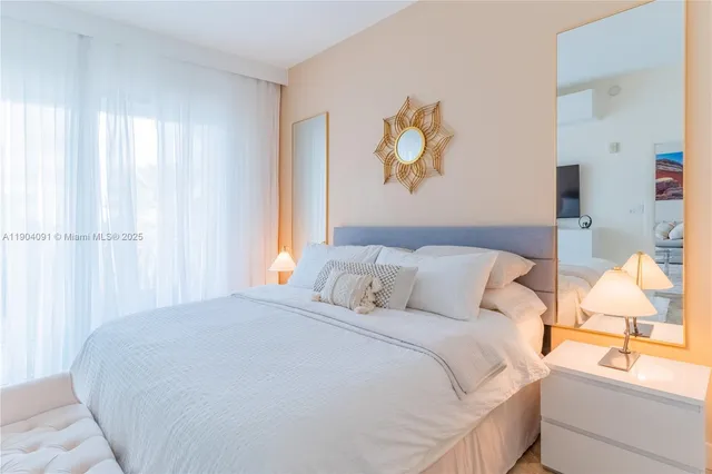 a bedroom with a bed and painting on the wall