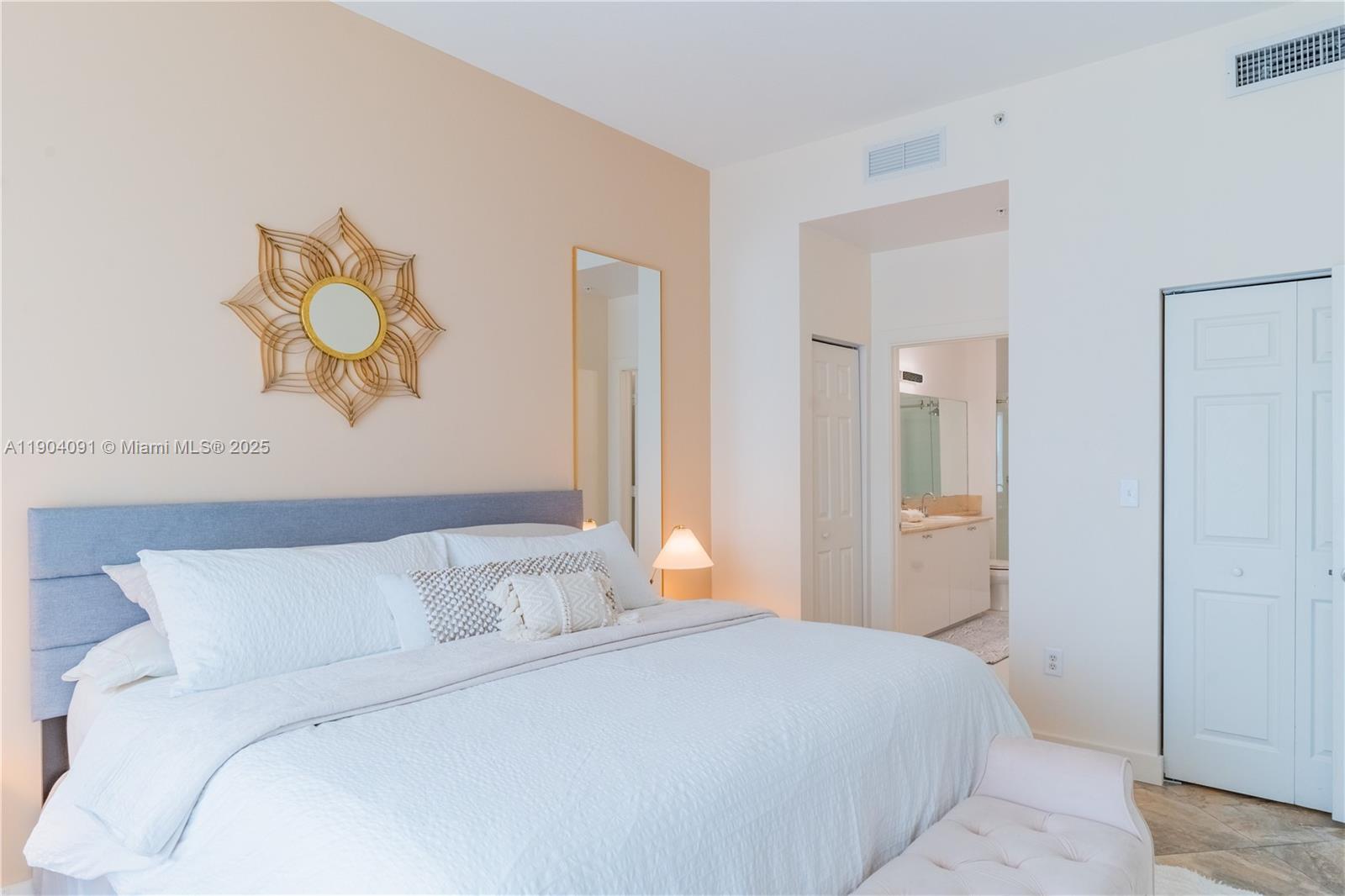 802 West Windward Way, Unit 411 Lantana, FL 33462 - Photo 19 of 42 a bedroom with a bed and a painting on the wall