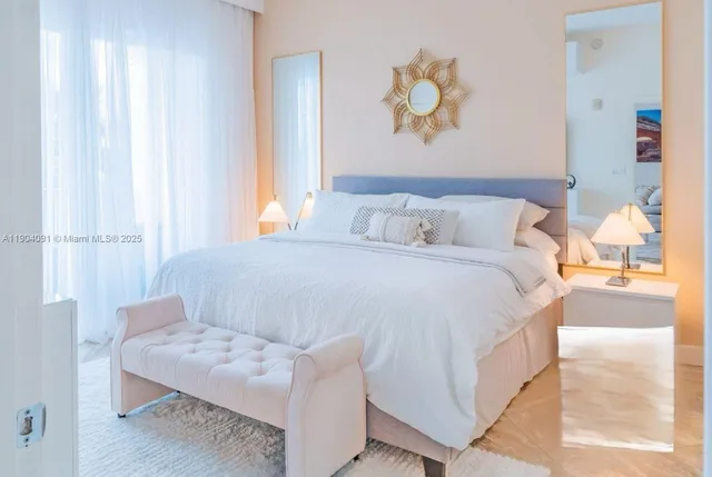 a bedroom with a bed and a painting on the wall