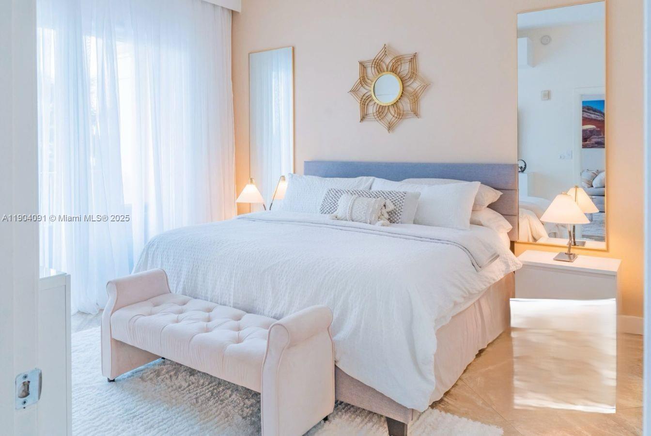 802 West Windward Way, Unit 411 Lantana, FL 33462 - Photo 2 of 42 a bedroom with a bed and a painting on the wall