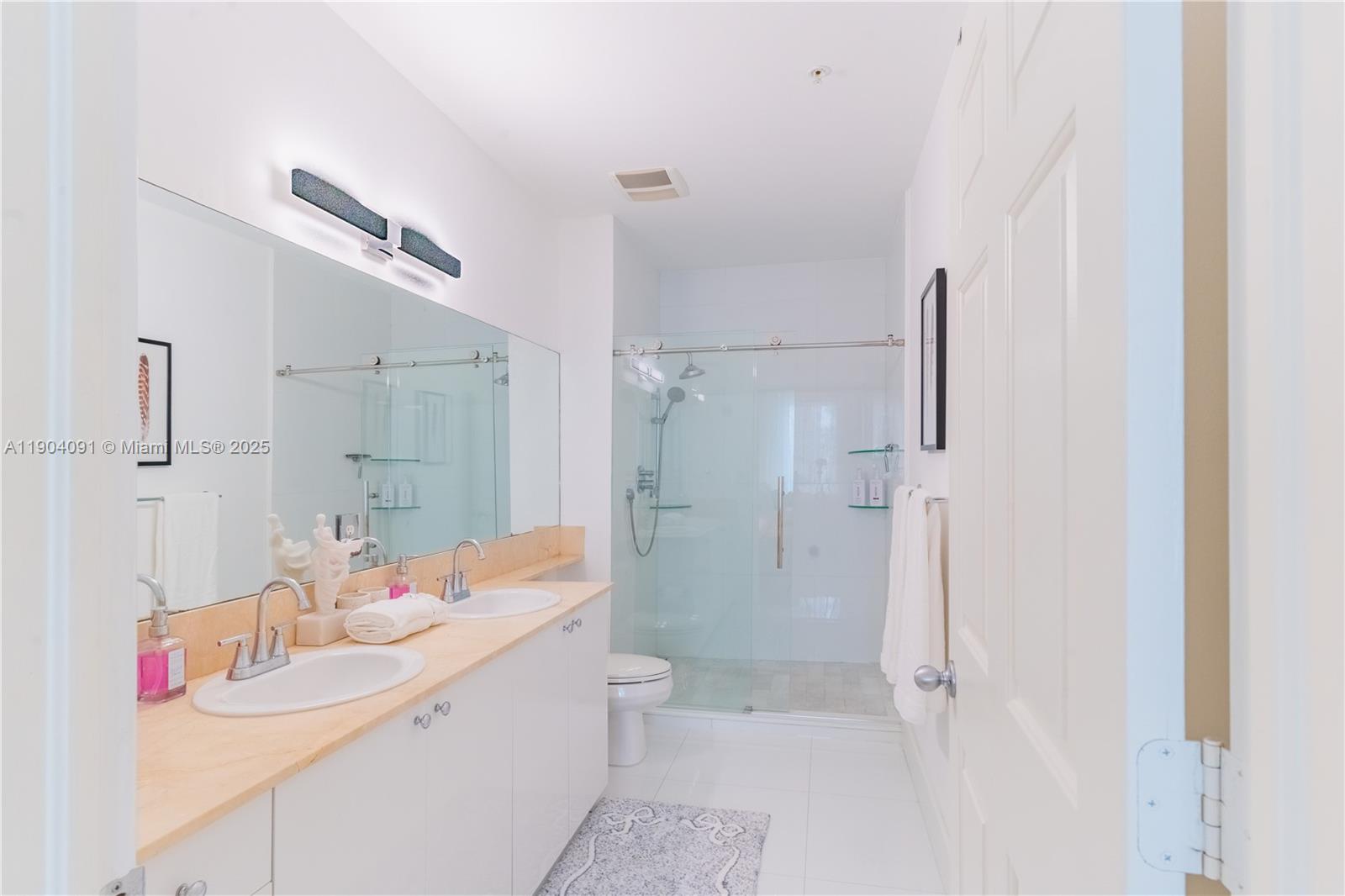 802 West Windward Way, Unit 411 Lantana, FL 33462 - Photo 22 of 42 a bathroom with a sink toilet double vanity and shower